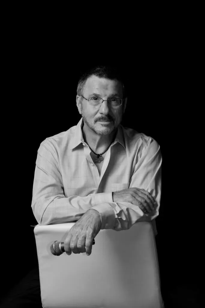 A man sitting in a chair with his arms crossed.